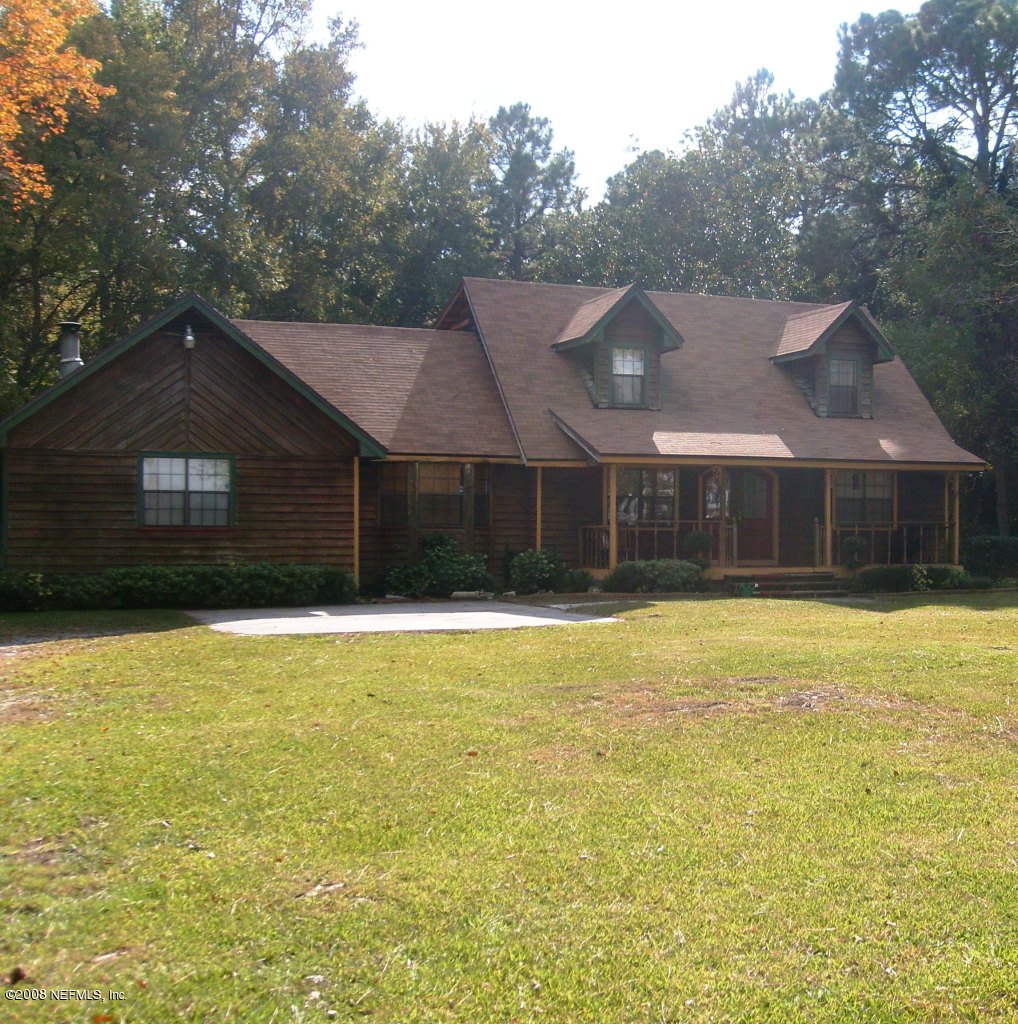45208 Bismark Road Callahan, FL 32011 - Photo 3 of 7 a house that has a swimming pool in front of it