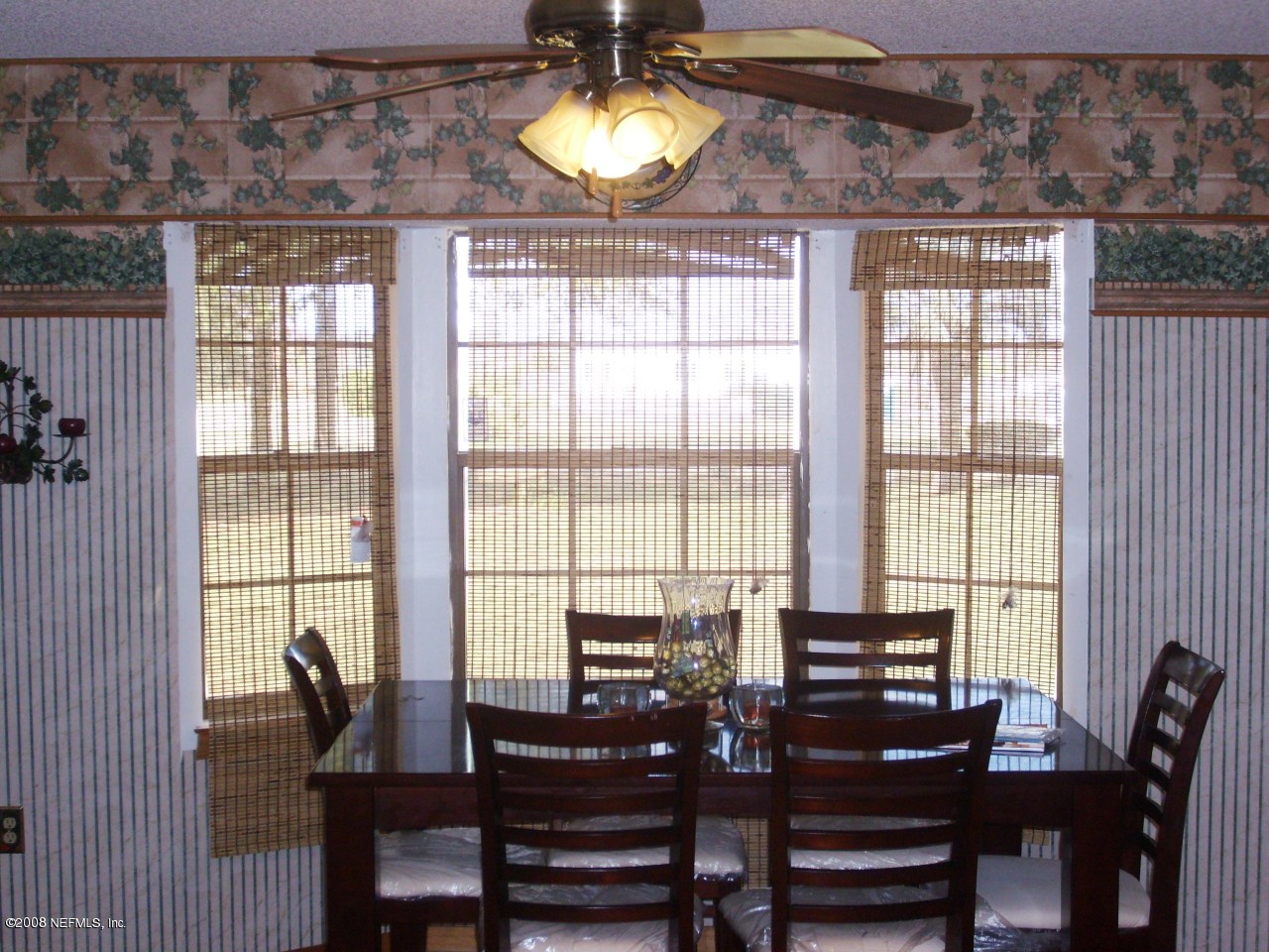 45208 Bismark Road Callahan, FL 32011 - Photo 4 of 7 a view of a dining room with furniture and chandelier