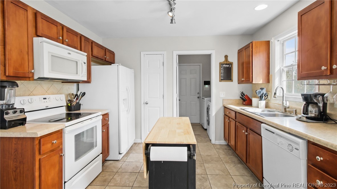 2219 Gray Goose Loop Fayetteville, NC 28306 - Photo 11 of 36 a kitchen with stainless steel appliances granite countertop a stove a sink and a refrigerator