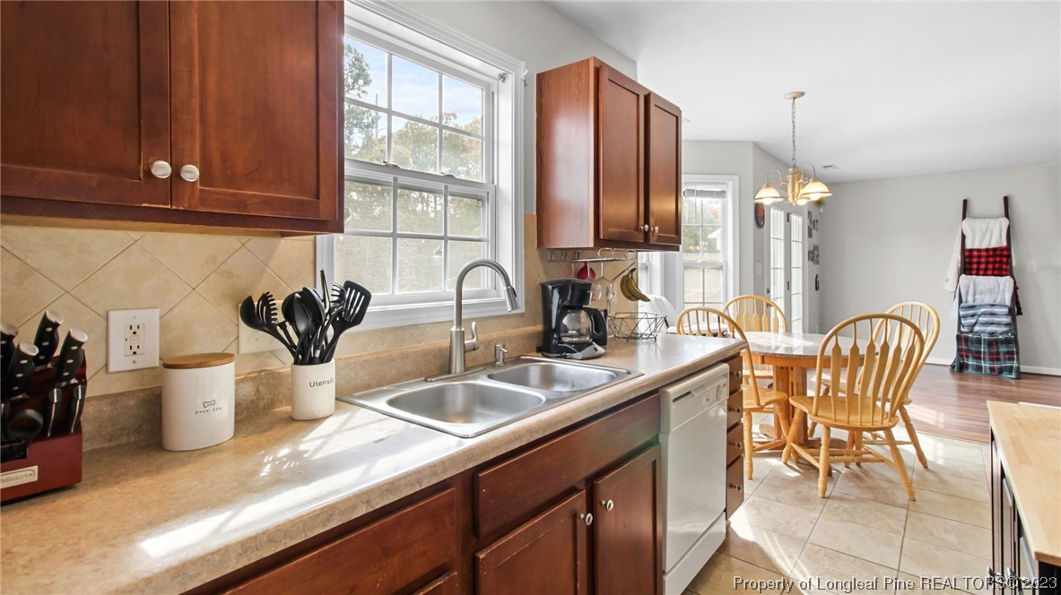 2219 Gray Goose Loop Fayetteville, NC 28306 - Photo 13 of 36 a kitchen with a sink and cabinets