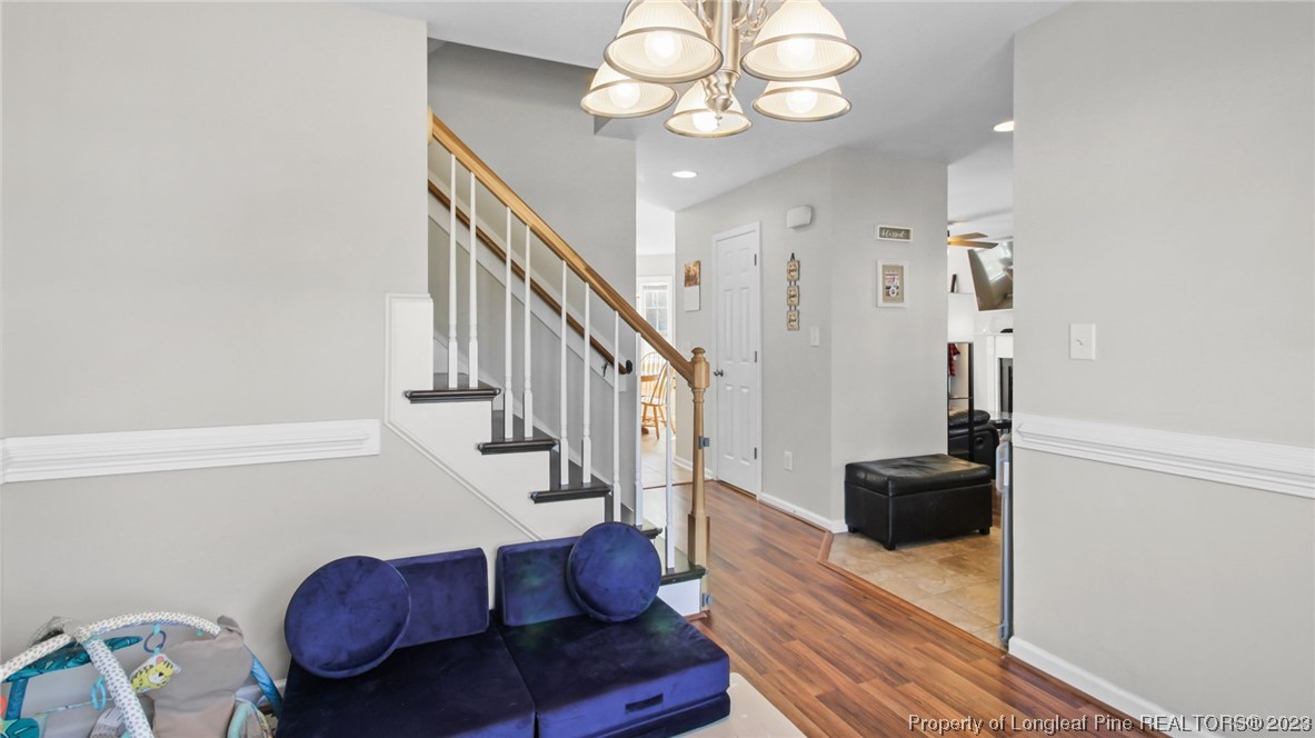 2219 Gray Goose Loop Fayetteville, NC 28306 - Photo 16 of 36 a view of a livingroom with furniture a chandelier