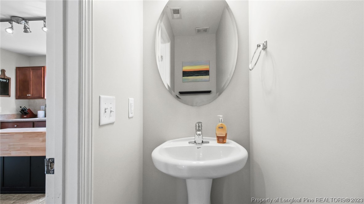 2219 Gray Goose Loop Fayetteville, NC 28306 - Photo 18 of 36 a bathroom with a sink and a mirror