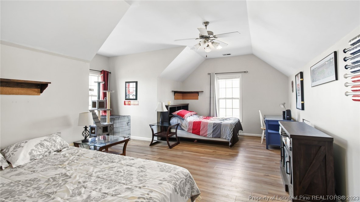 2219 Gray Goose Loop Fayetteville, NC 28306 - Photo 19 of 36 a bedroom with a bed and wooden floor
