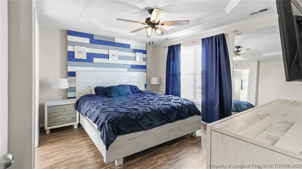 2219 Gray Goose Loop Fayetteville, NC 28306 - Photo 23 of 36 a bedroom with a bed and a chandelier