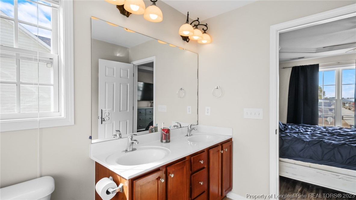 2219 Gray Goose Loop Fayetteville, NC 28306 - Photo 25 of 36 a en suite bathroom with a double vanity sink and a mirror