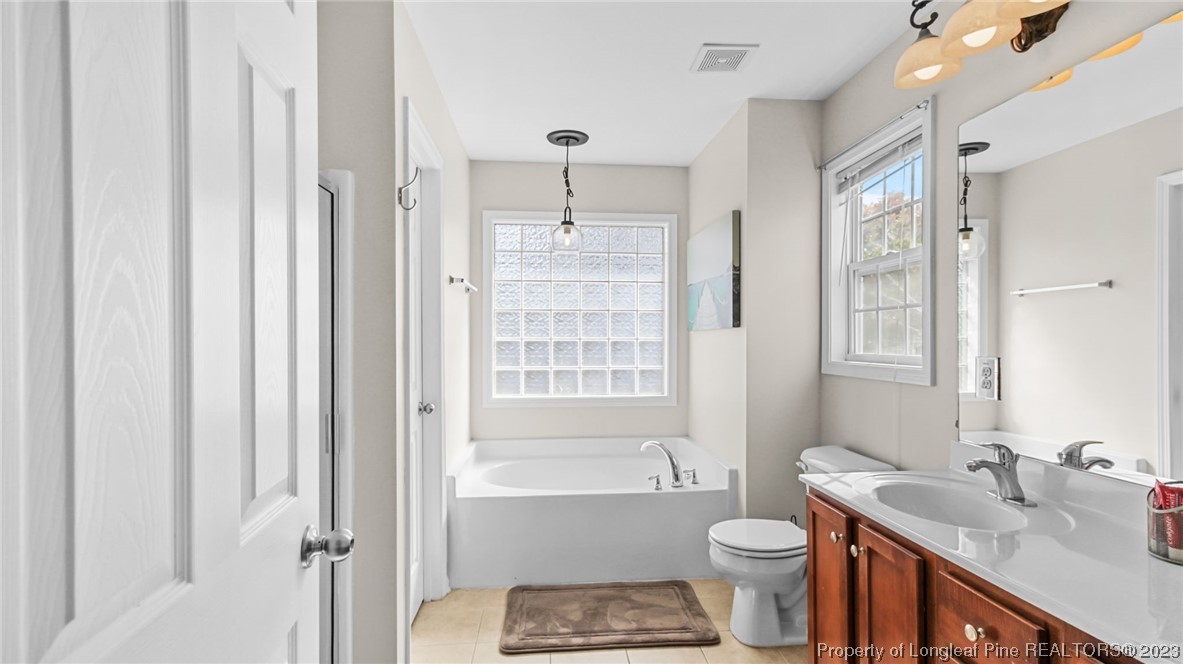 2219 Gray Goose Loop Fayetteville, NC 28306 - Photo 26 of 36 a bathroom with a sink toilet and shower