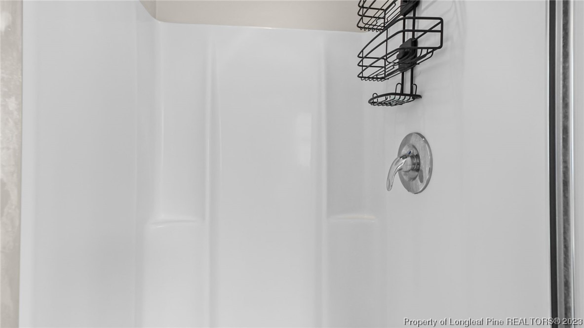 2219 Gray Goose Loop Fayetteville, NC 28306 - Photo 28 of 36 a view of a room with a hanging light and wood floor