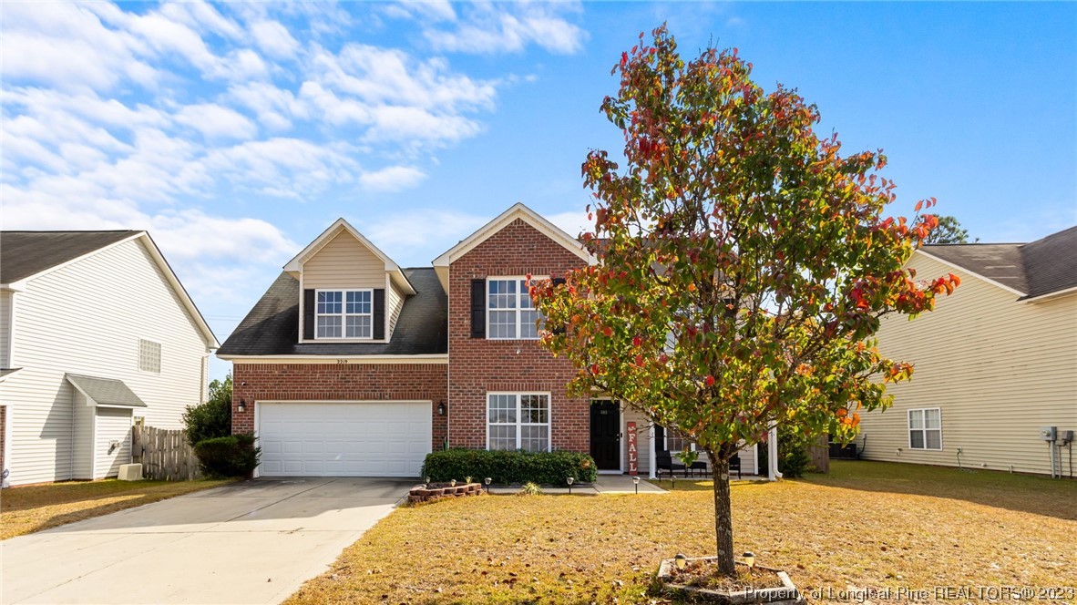 2219 Gray Goose Loop Fayetteville, NC 28306 - Photo 4 of 36 a front view of a house with a yard