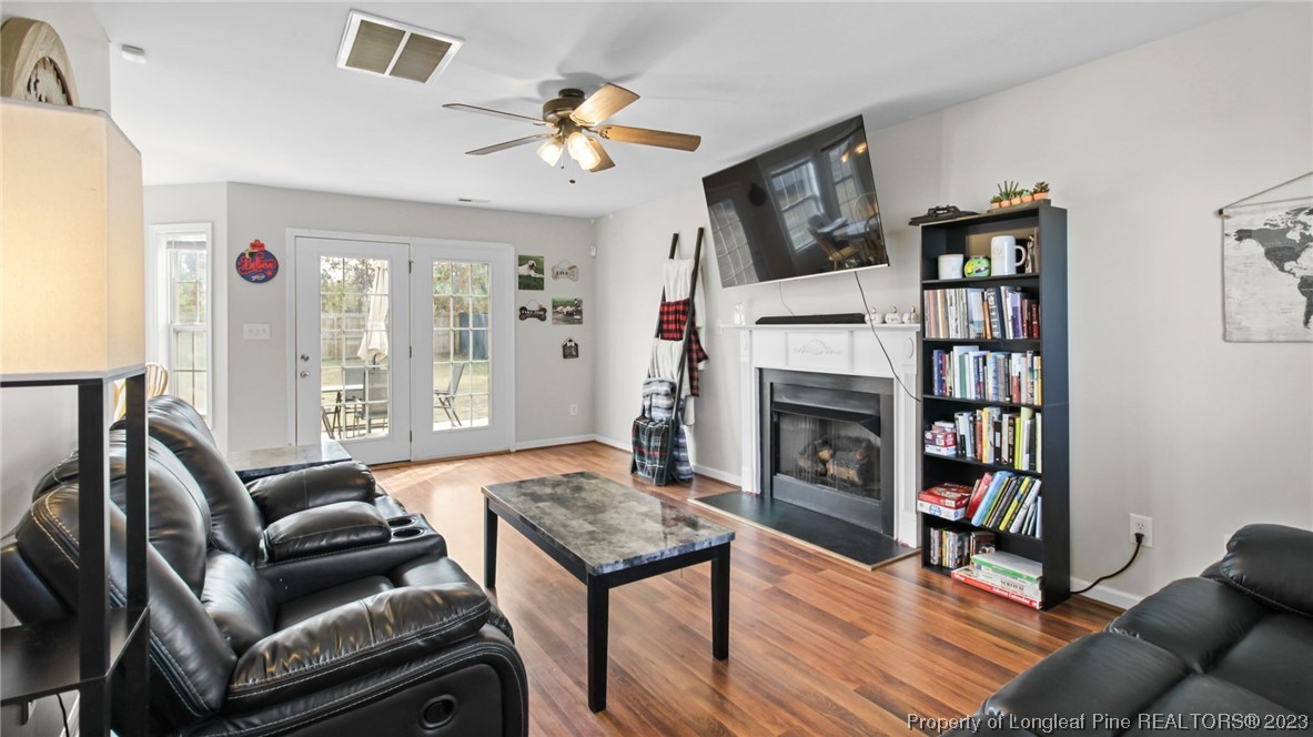 2219 Gray Goose Loop Fayetteville, NC 28306 - Photo 7 of 36 a living room with furniture fireplace and wooden floor