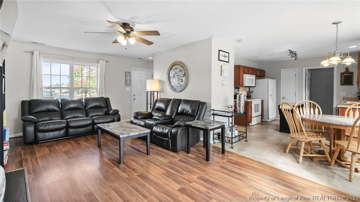 2219 Gray Goose Loop Fayetteville, NC 28306 - Photo 8 of 36 a living room with furniture a wooden floor and a window