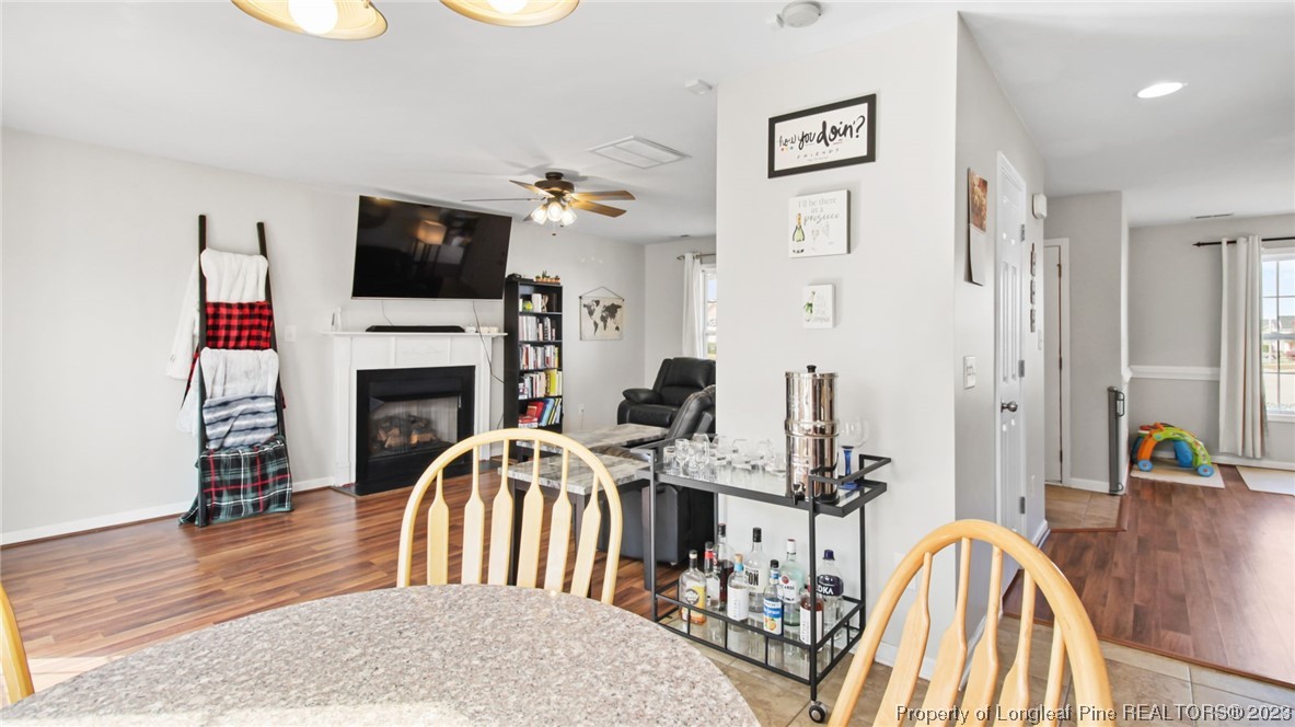 2219 Gray Goose Loop Fayetteville, NC 28306 - Photo 10 of 36 a living room with furniture a fireplace and a flat screen tv
