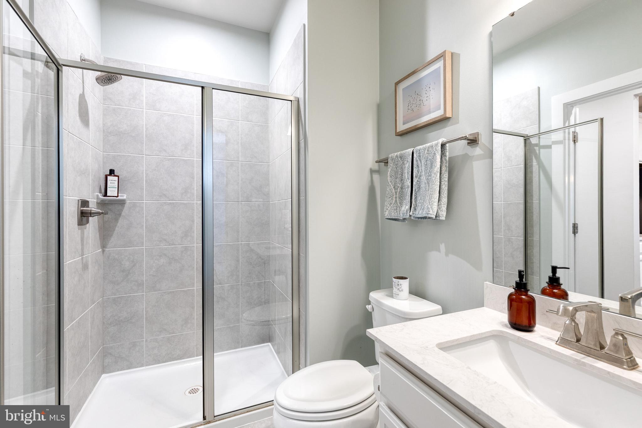 6003 Valentine Way Hanover, MD 21076 - Photo 28 of 52 a bathroom with a sink toilet and shower