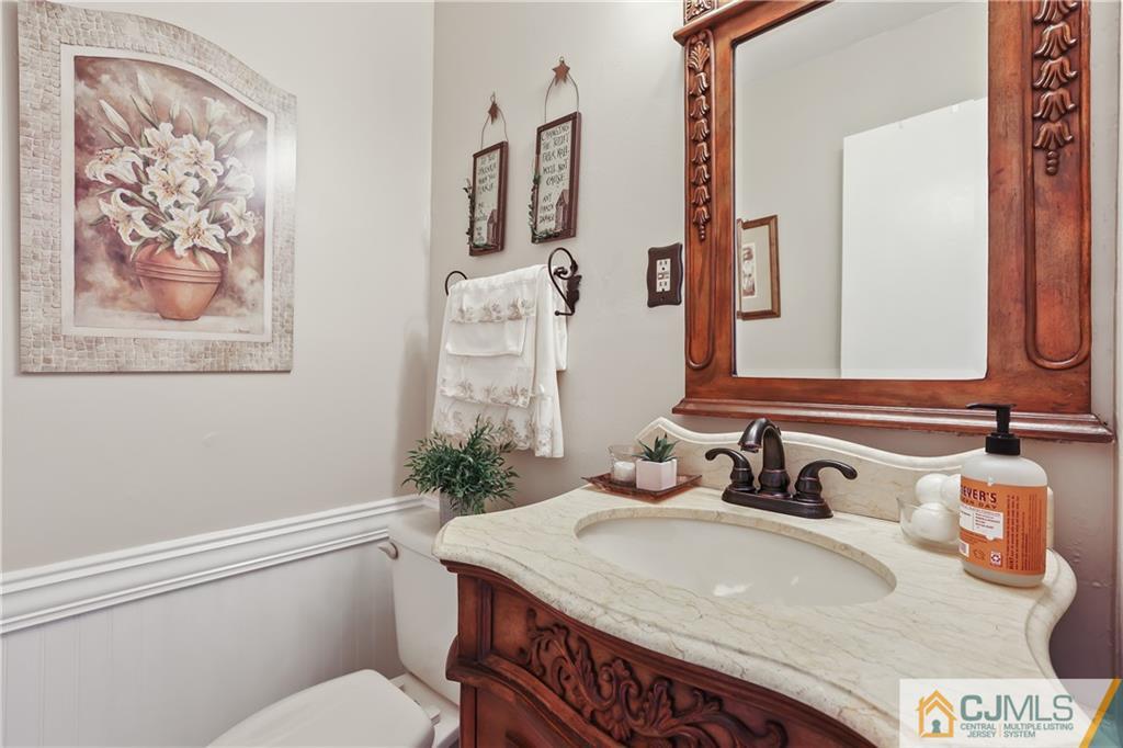 49 South Rhoda Street Monroe Township, NJ 08831 - Photo 5 of 11 a bathroom with a toilet sink and mirror