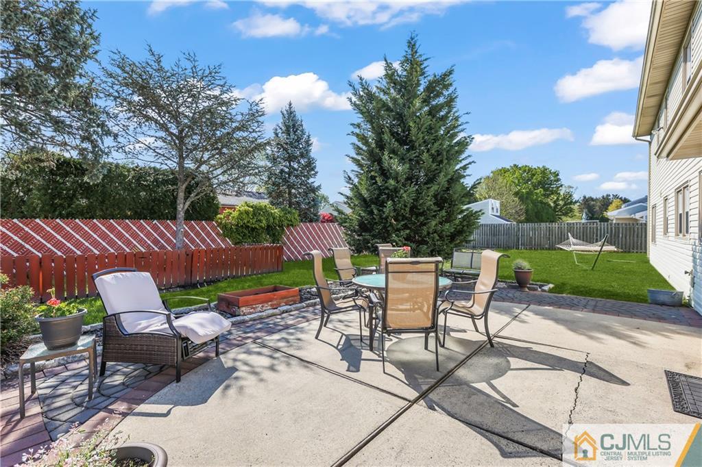 49 South Rhoda Street Monroe Township, NJ 08831 - Photo 7 of 11 a view of a patio with a table and chairs