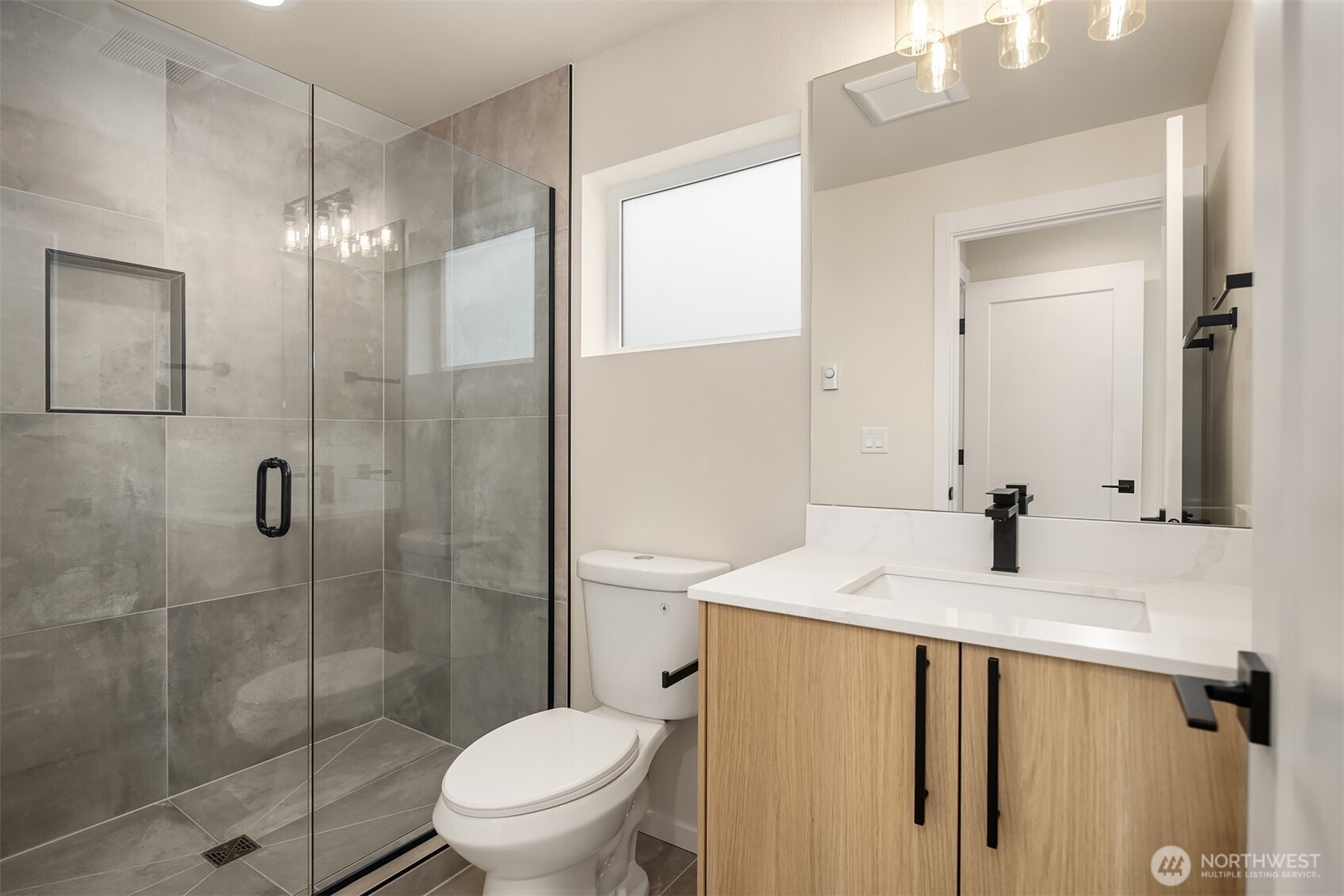 6503 Dibble Avenue Northwest Seattle, WA 98117 - Photo 13 of 15 a bathroom with a sink toilet and shower