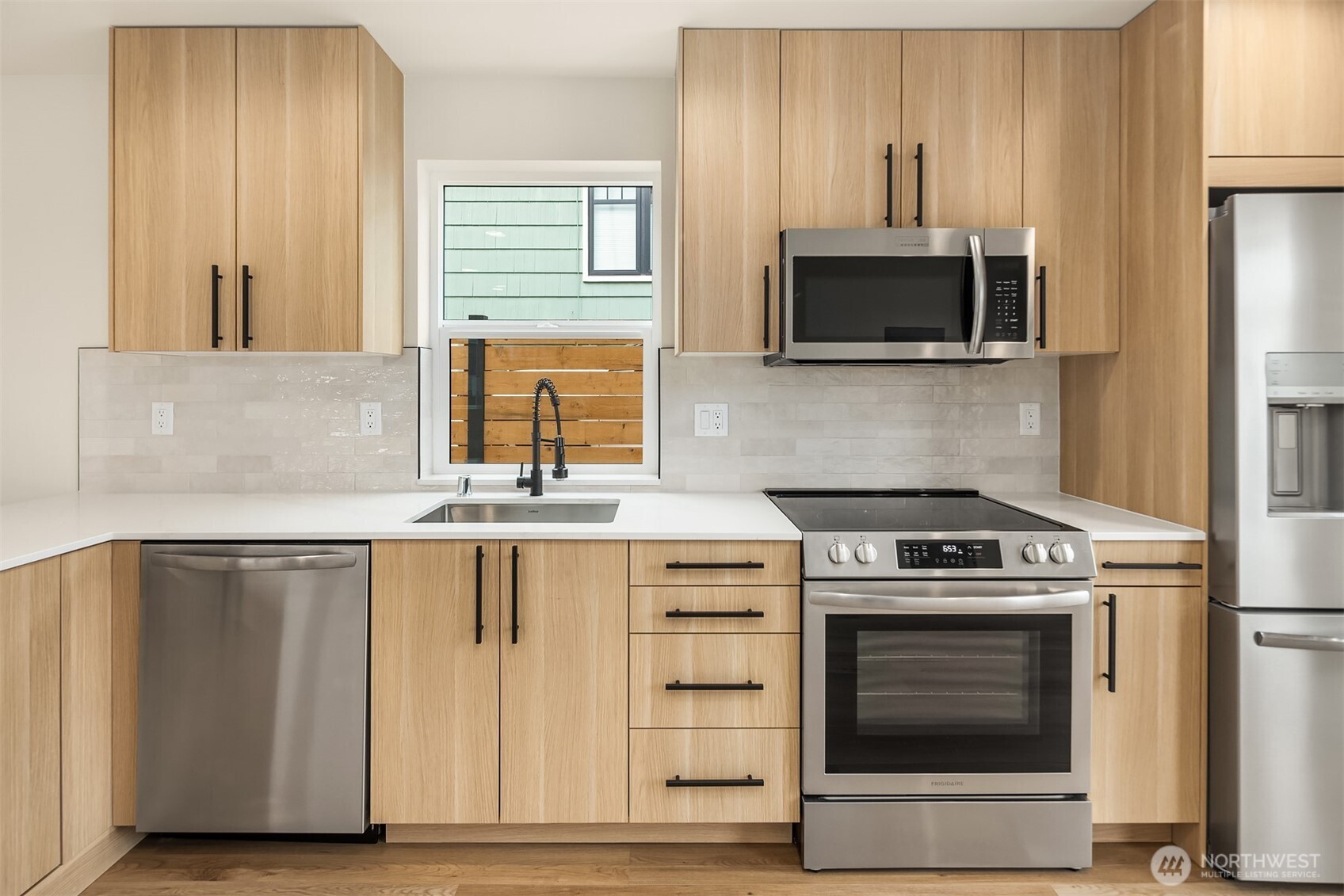 6503 Dibble Avenue Northwest Seattle, WA 98117 - Photo 4 of 15 a kitchen with a stove and a microwave