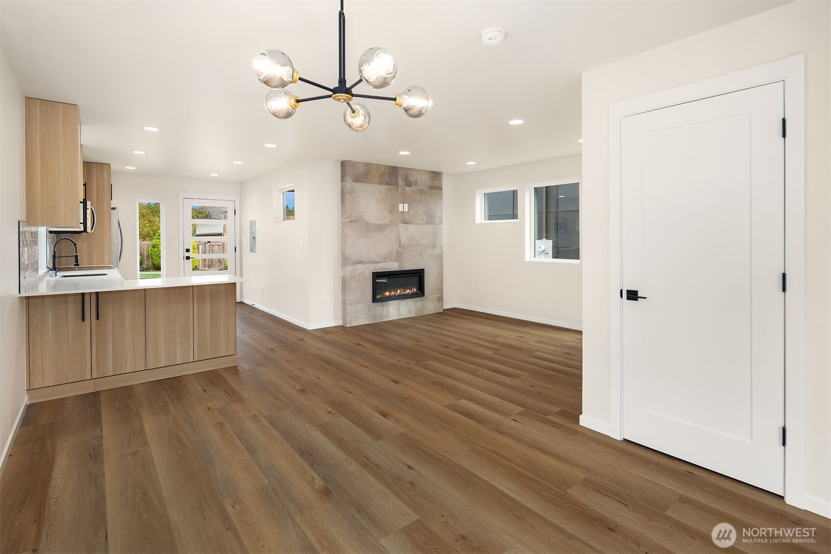 6503 Dibble Avenue Northwest Seattle, WA 98117 - Photo 9 of 15 a view of an empty room with window and wooden floor