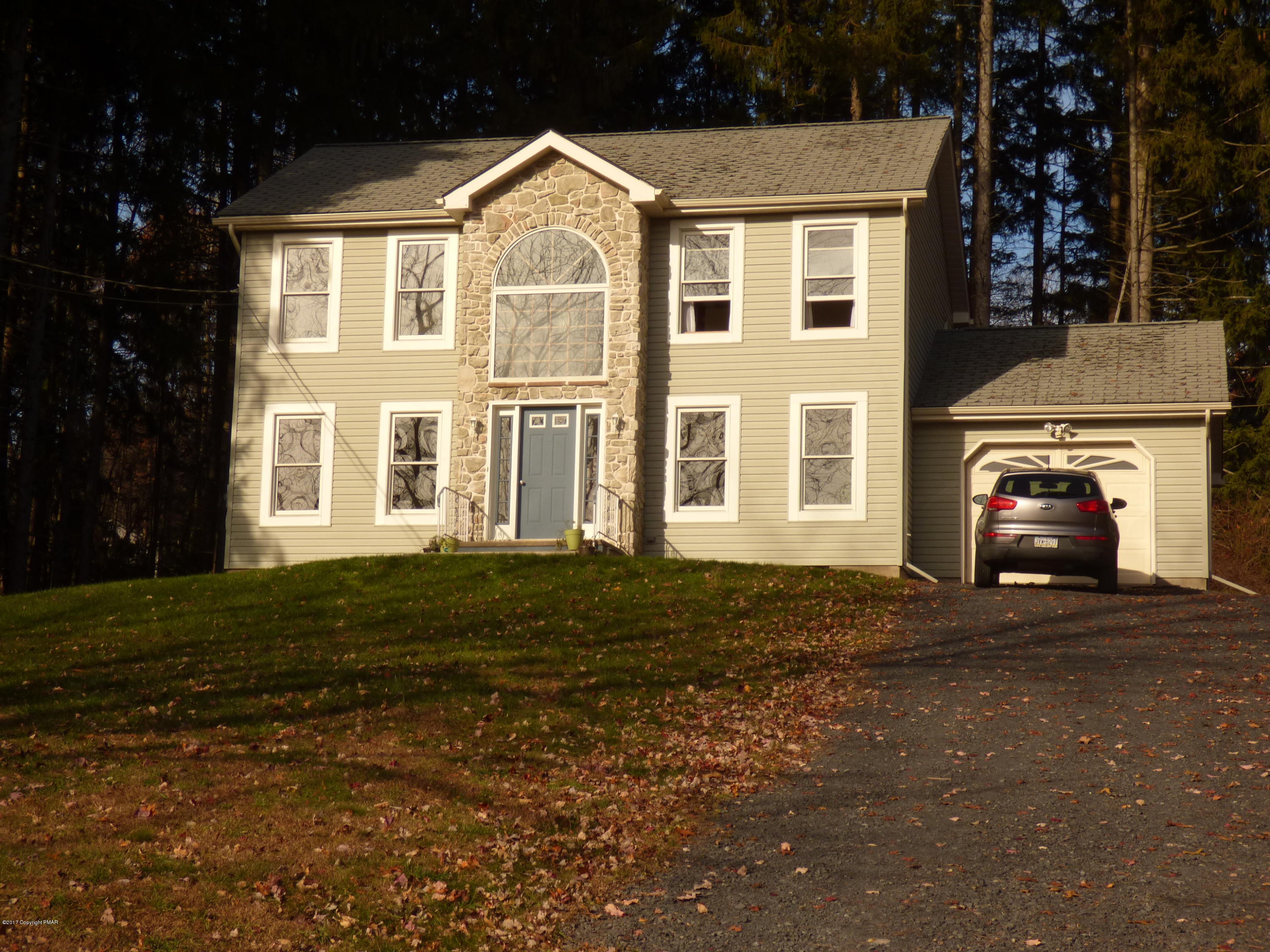 277 Rinker Road Stroudsburg, PA 18360 - Photo 1 of 17 a front view of a house with a garden