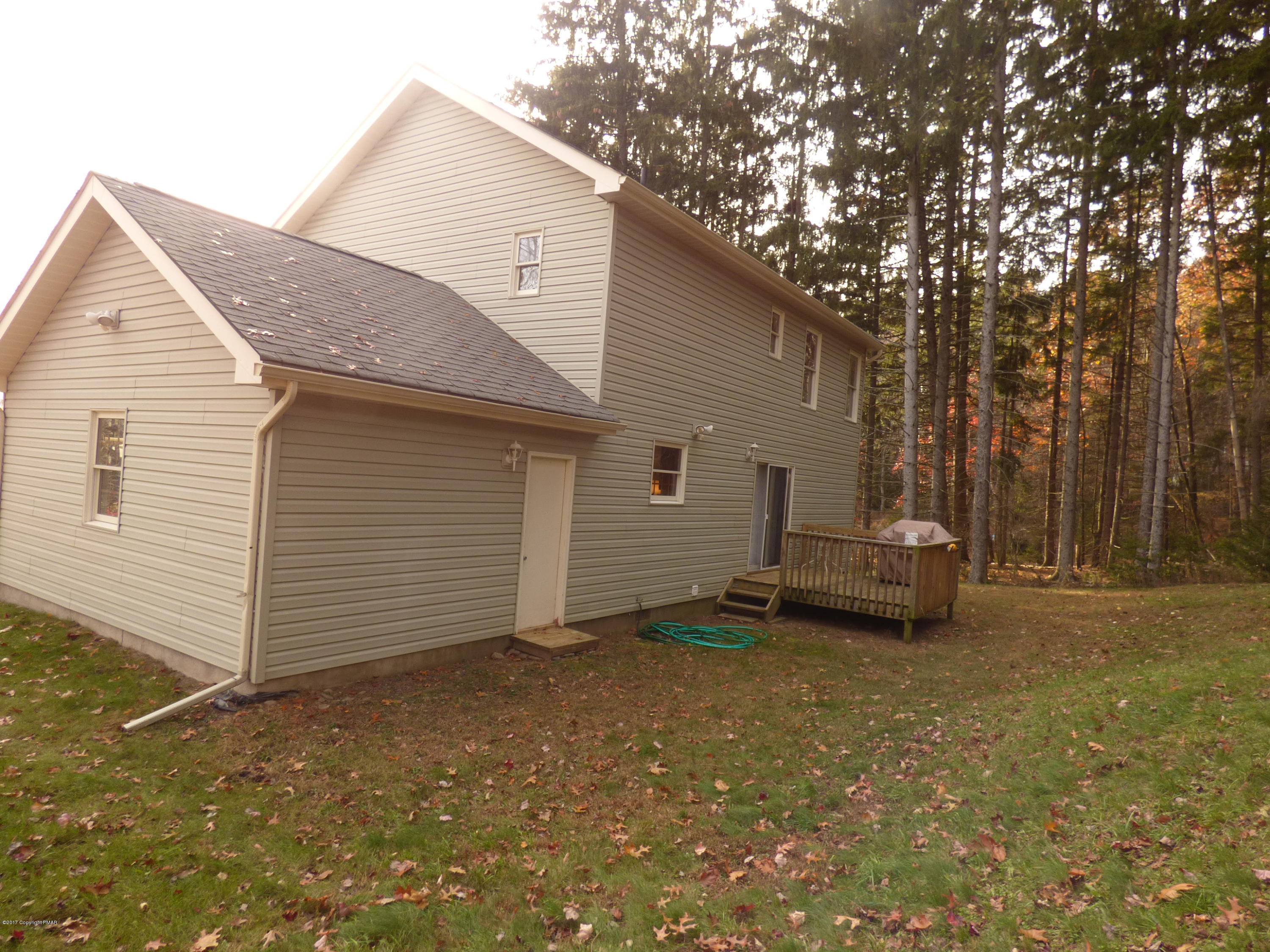 277 Rinker Road Stroudsburg, PA 18360 - Photo 17 of 17 a white house covered with tall trees