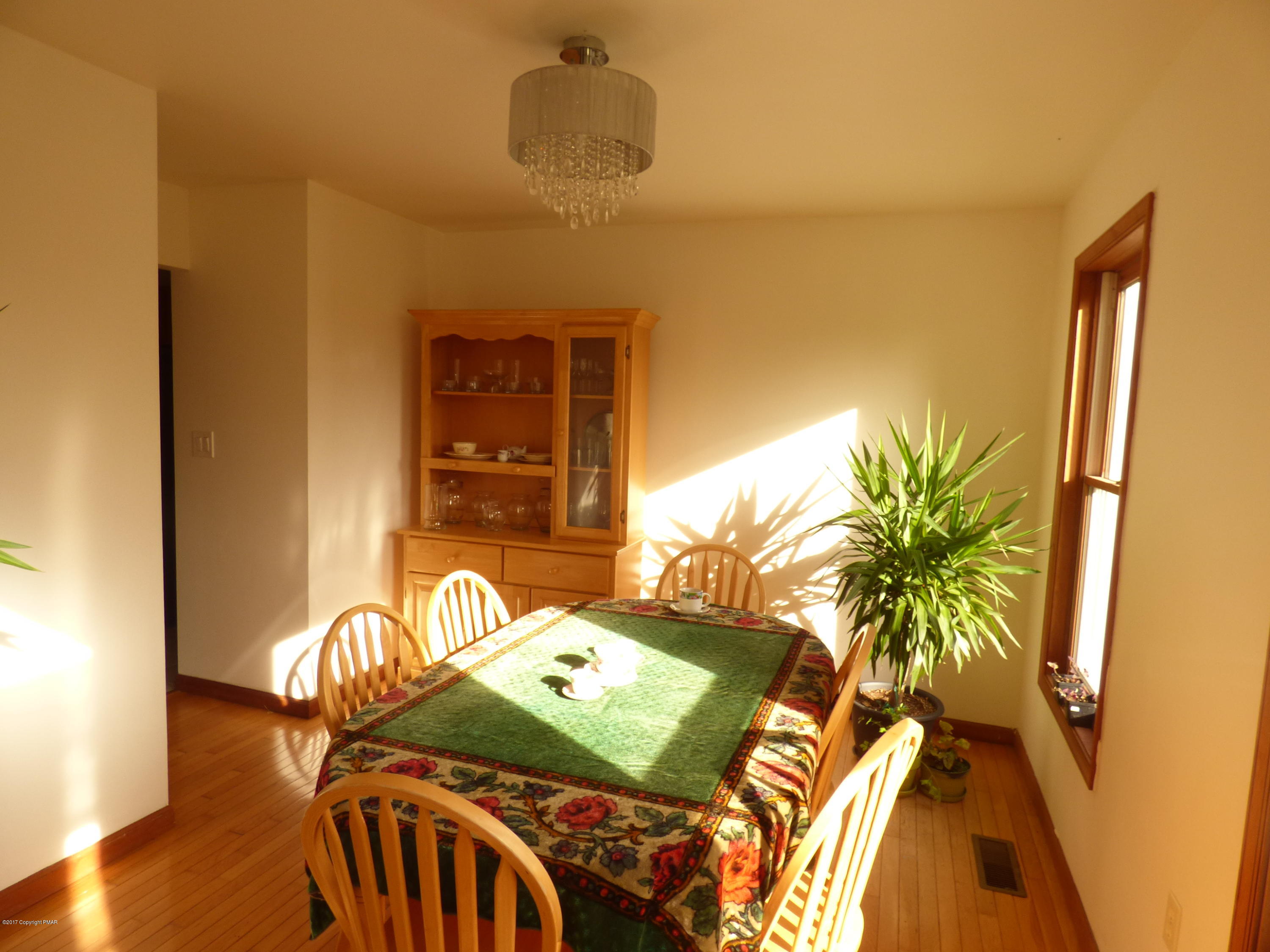 277 Rinker Road Stroudsburg, PA 18360 - Photo 5 of 17 a bedroom with a bed and a potted plant next to a window