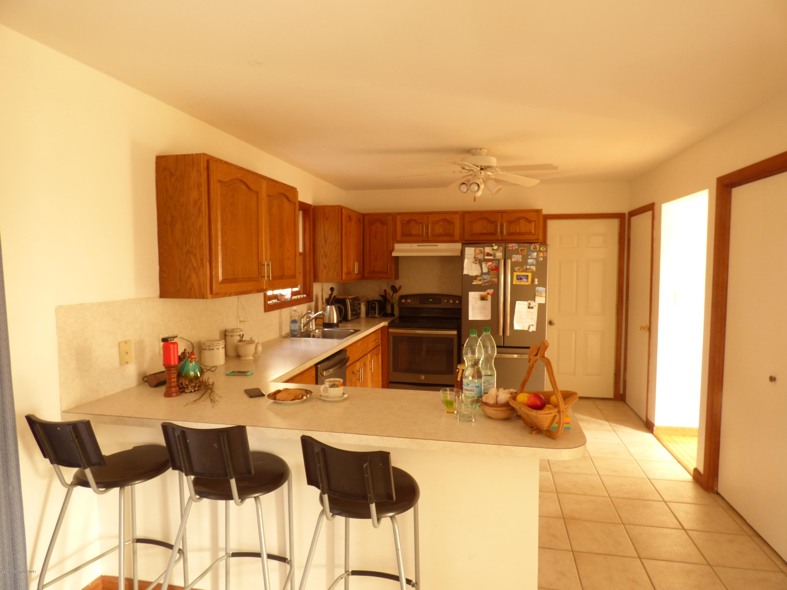 277 Rinker Road Stroudsburg, PA 18360 - Photo 8 of 17 a view of a kitchen with kitchen island dining table and chairs