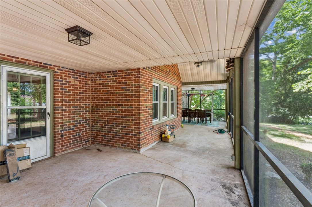 321 South Pine Street Walhalla, SC 29691 - Photo 5 of 28 A spacious screened porch offers a tranquil retreat overlooking lush greenery.