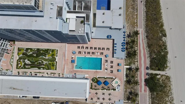 a view of a cars park in front of a building