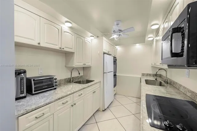 a kitchen with granite countertop a sink and cabinets