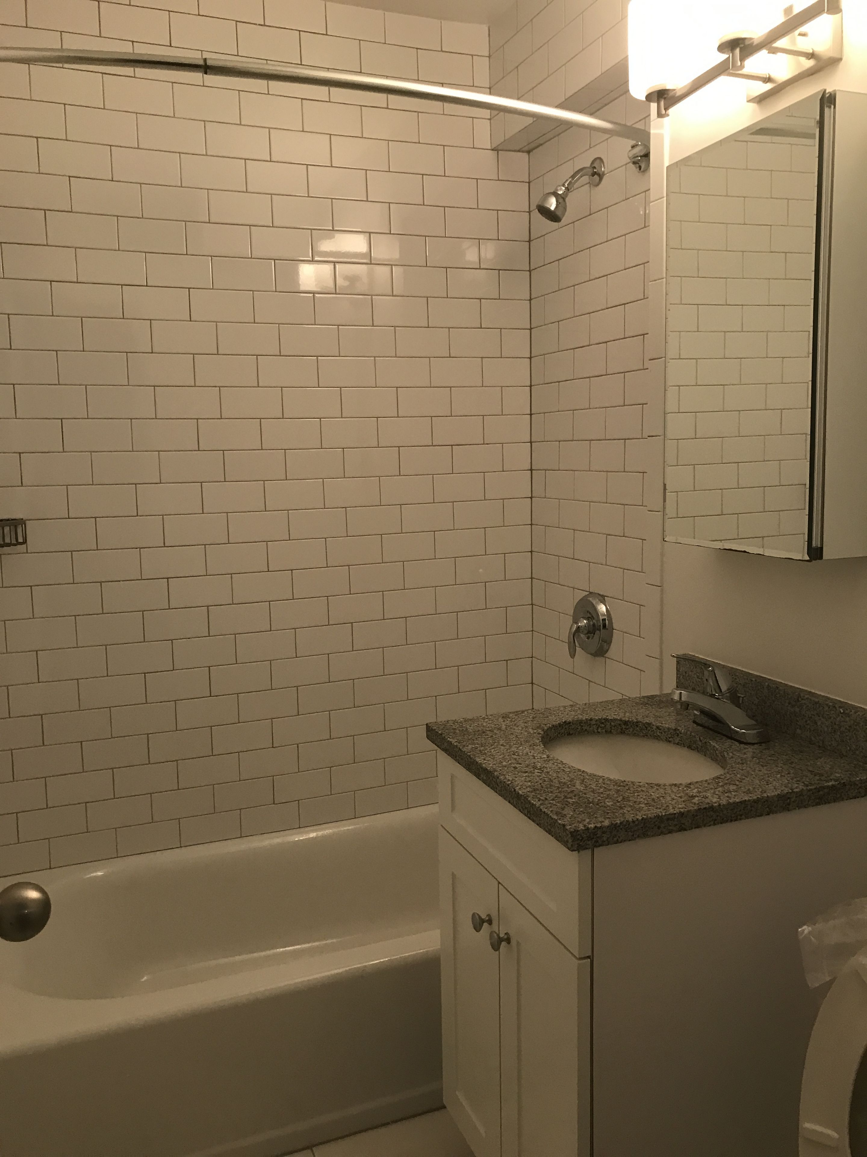 59-17 Junction Boulevard, Unit 3J Queens, NY 11368 - Photo 3 of 5 a bathroom with a granite countertop sink a toilet and shower