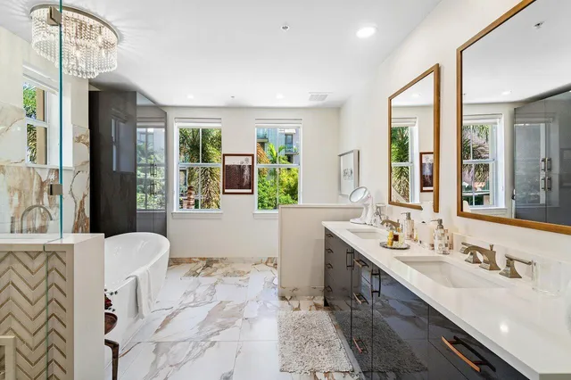 a spacious bathroom with a double vanity sink mirror and double