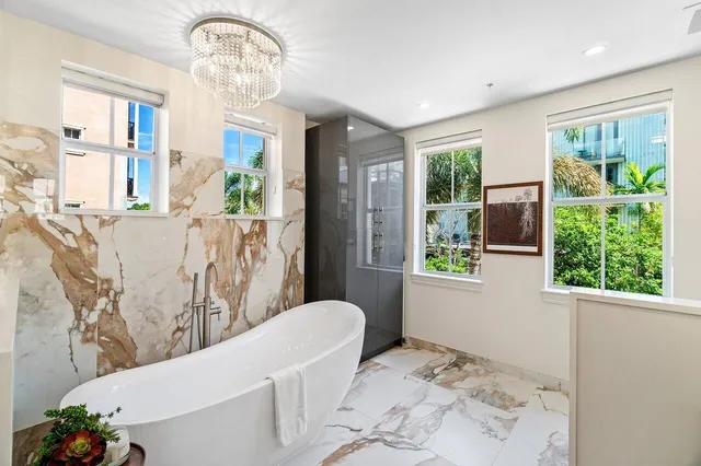 a white bath tub sitting next to a bathroom