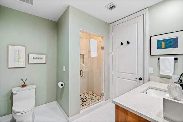 a bathroom with a toilet sink and shower