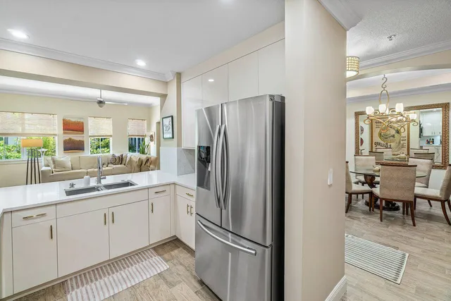 a kitchen with a sink stainless steel appliances and cabinets