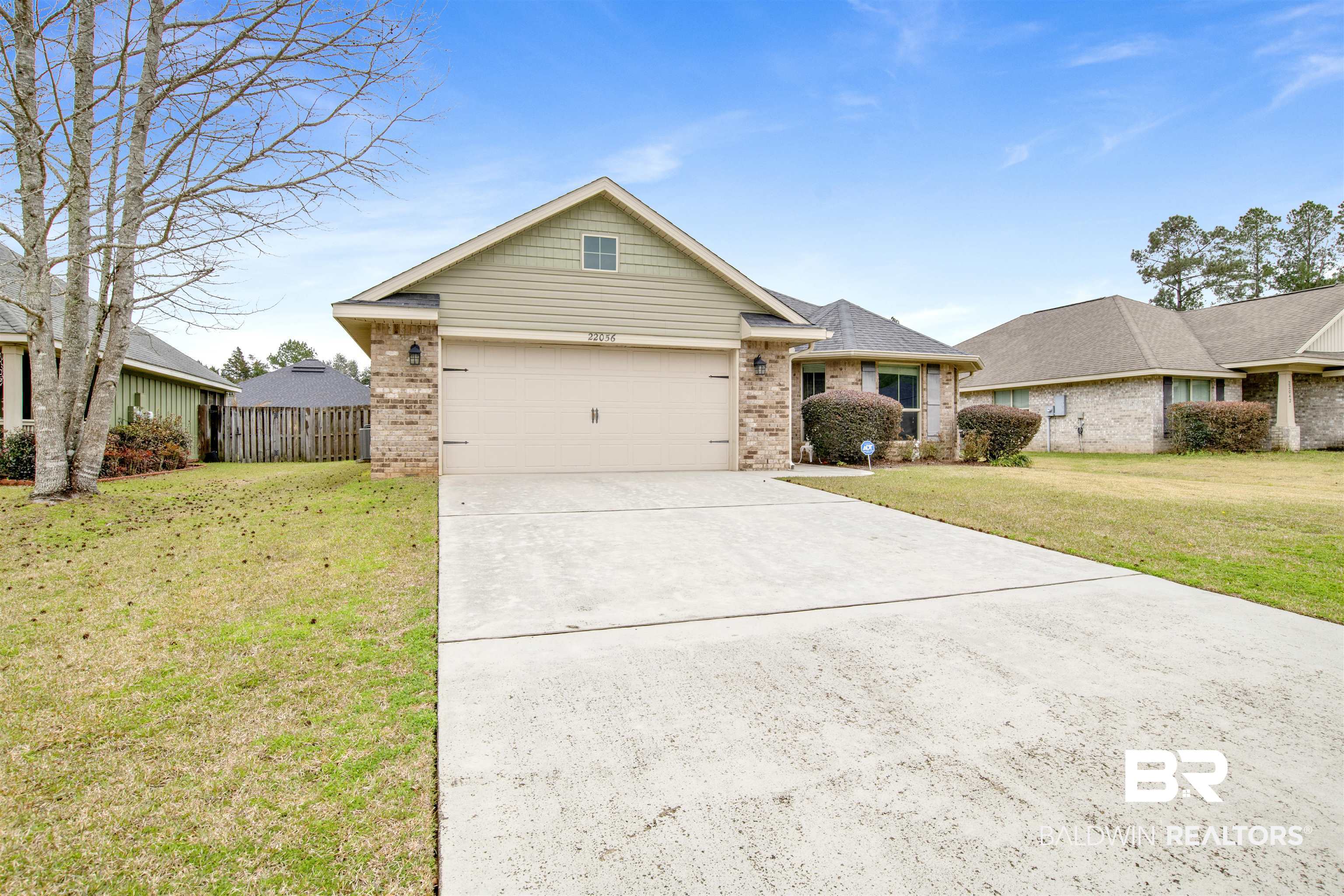 22056 Garland Loop Silverhill, AL 36576 - Photo 26 of 28 View of front of property featuring fence, an attached garage, driveway, a front yard, and brick siding