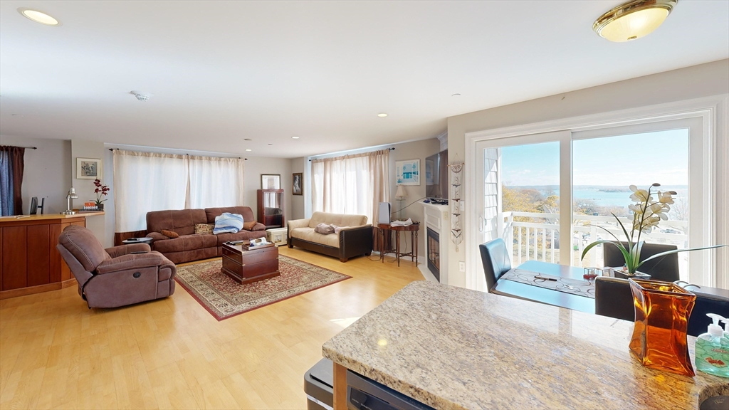 205 Onset Avenue, Unit 402 Wareham, MA 02558 - Photo 2 of 11 a living room with furniture and a large window