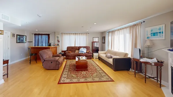 a living room with furniture rug and window