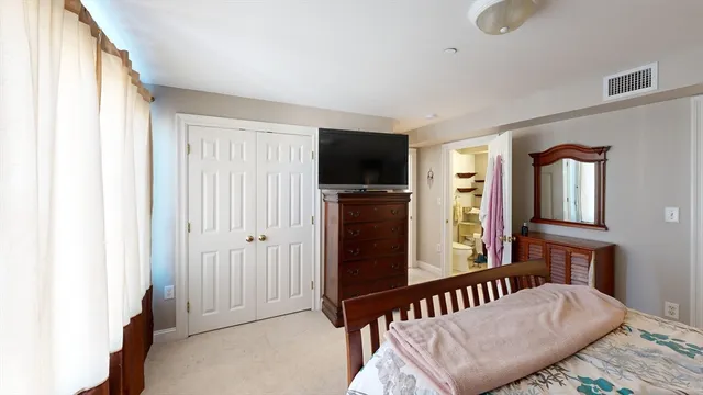 a bedroom with furniture and a window