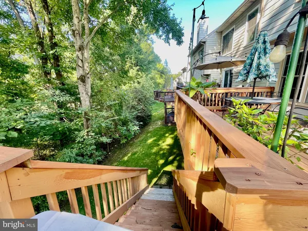 a balcony with wooden floor and outdoor seating
