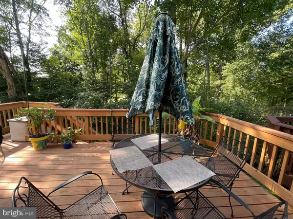 a view of balcony with wooden floor and outdoor seating