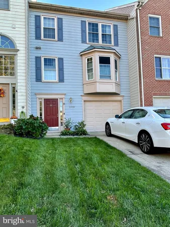 a car parked in front of a brick house
