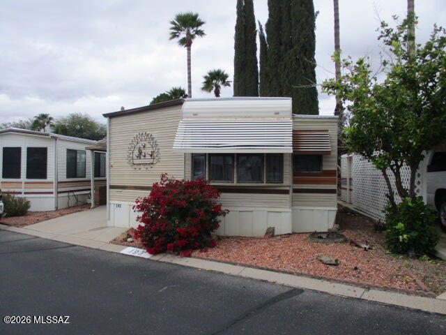 3100 South Kinney Road, Unit 193 Tucson, AZ 85713 - Photo 1 of 35 a front view of a house with a garden