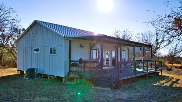 an aerial view of house with yard