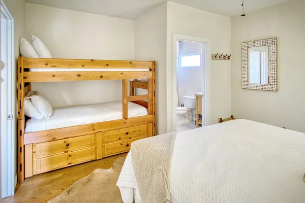 a bedroom with a bed and a refrigerator