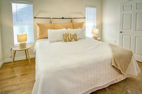 a bedroom with a bed and wooden floor