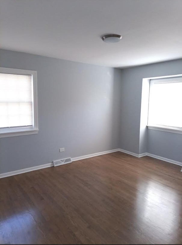 438 Hamilton Wood Homewood, IL 60430 - Photo 22 of 39 an empty room with wooden floor and windows