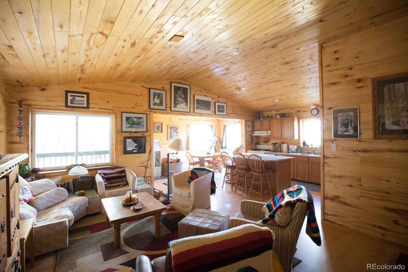 203 Hampton Run Road Mosca, CO 81146 - Photo 11 of 33 a living room with furniture and a large window