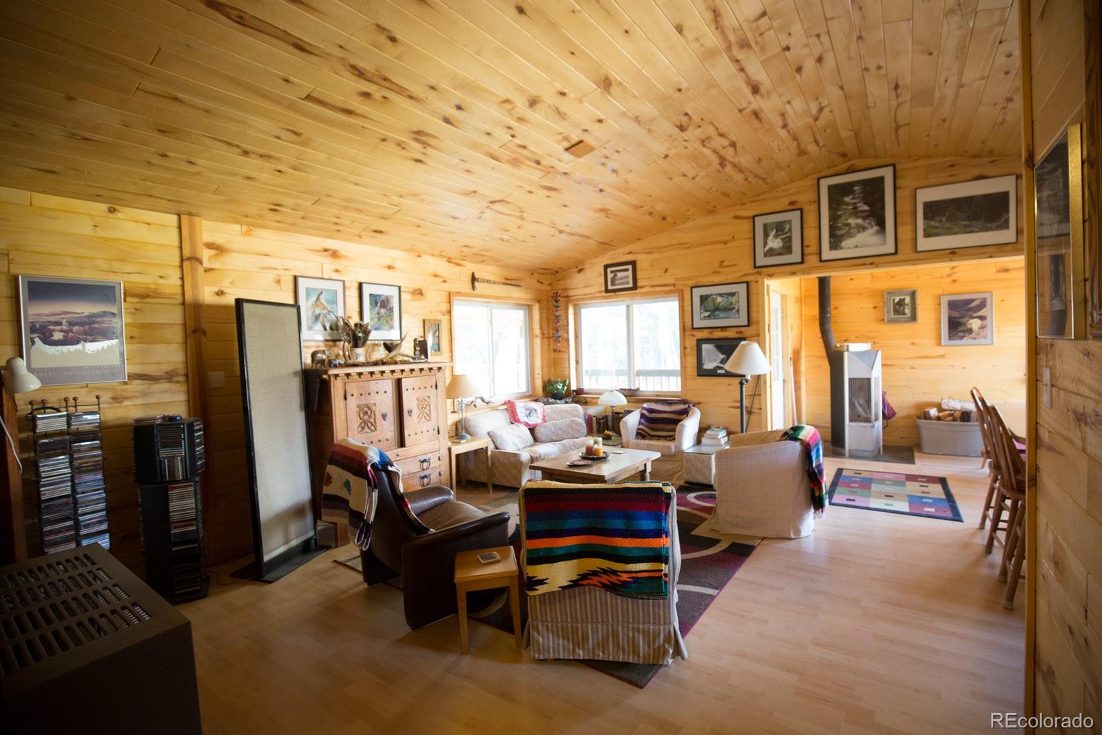 203 Hampton Run Road Mosca, CO 81146 - Photo 12 of 33 a living room with furniture a large window and stainless steel appliances