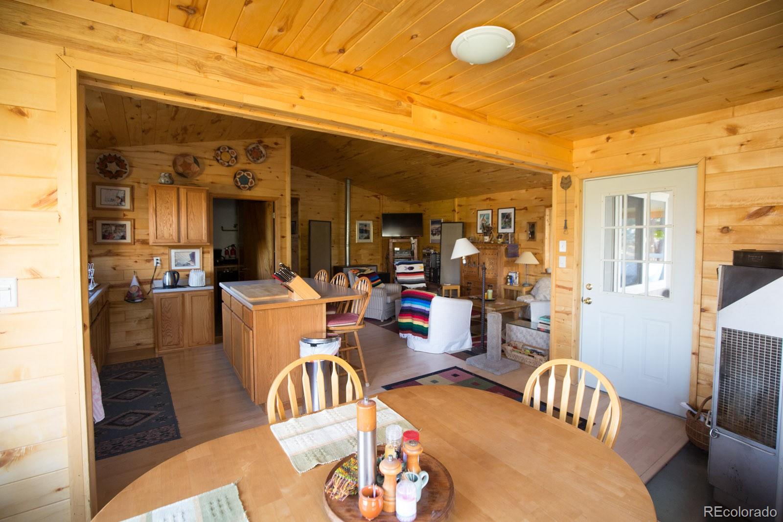 203 Hampton Run Road Mosca, CO 81146 - Photo 18 of 33 a view of a dining room and livingroom with furniture wooden floor and a rug
