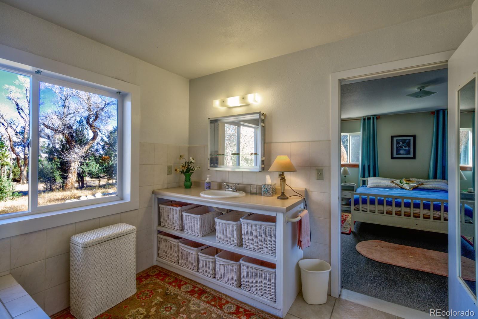 203 Hampton Run Road Mosca, CO 81146 - Photo 21 of 33 a living room with furniture a rug and a window