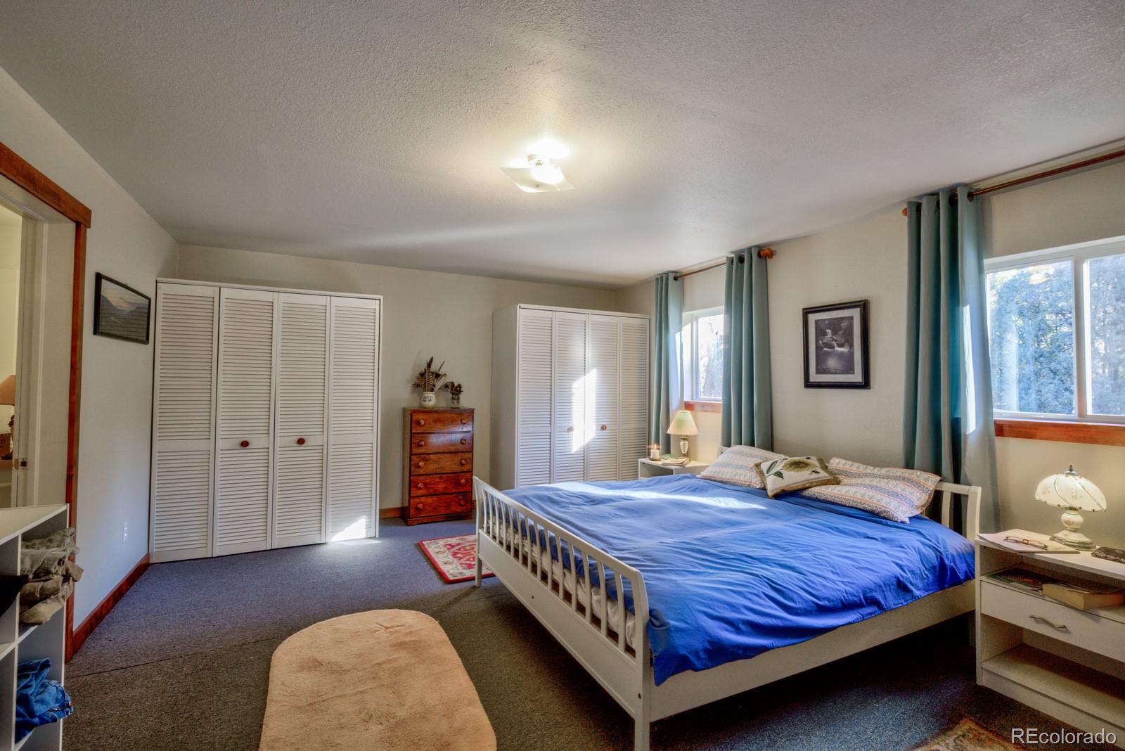 203 Hampton Run Road Mosca, CO 81146 - Photo 22 of 33 a bedroom with a bed and wooden floor